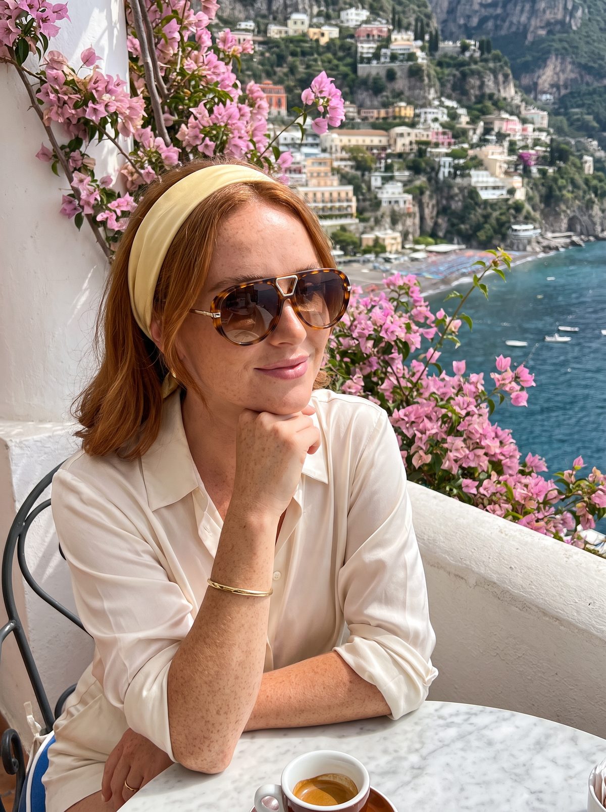 Woman at a Positano café wearing RIVA sunglasses